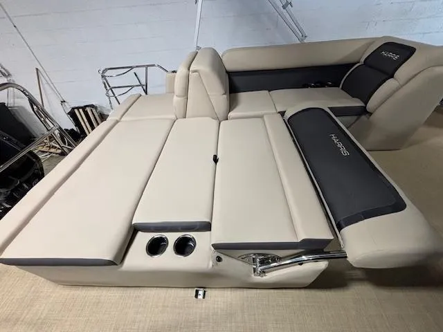 Slide: The Image of 2024 Harris Cruiser 210 boat interior with beige seating and cup holders. - 14