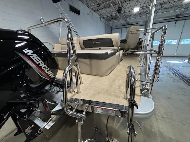 Slide: The Image of 2024 Harris Cruiser 210 pontoon boat with Mercury engine in a showroom. - 15
