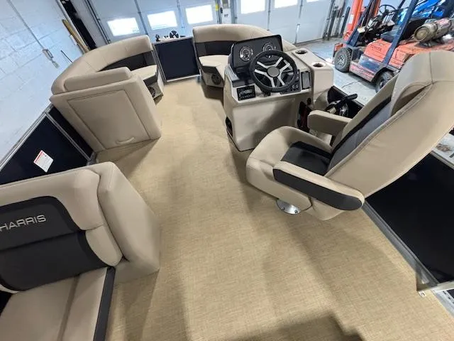 Slide: The Image of 2024 Harris Cruiser 210 interior with beige seating and modern steering console. - 18