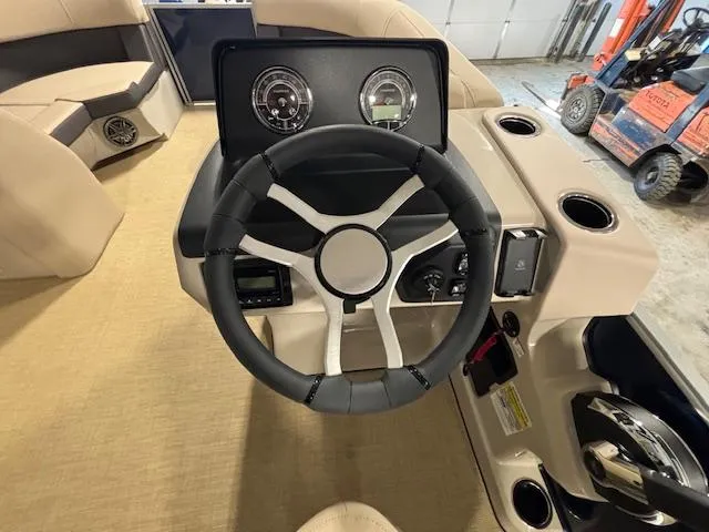 Slide: The Image of 2024 Harris Cruiser 210 boat steering wheel and dashboard in a showroom. - 20