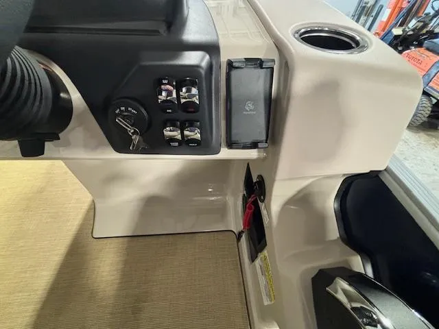 Slide: The Image of 2024 Harris Cruiser 210 dashboard with controls and ignition key. - 21