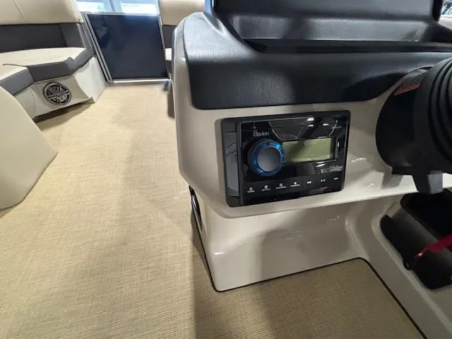 Slide: The Image of 2024 Harris Cruiser 210 interior with audio system and seating area. - 23