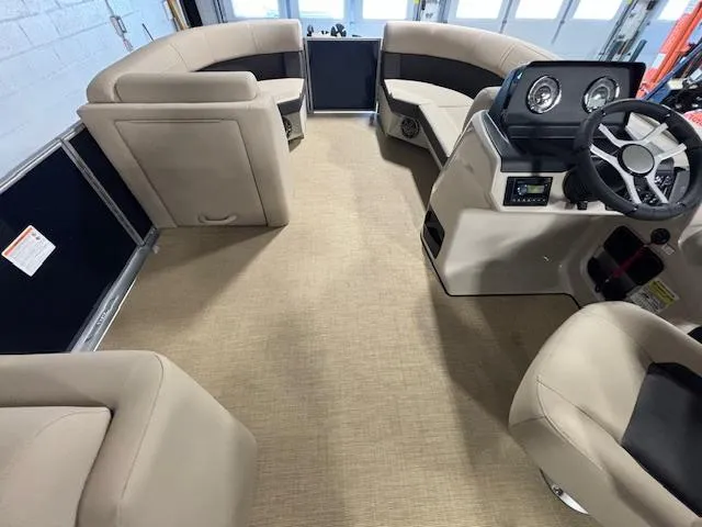 Slide: The Image of 2024 Harris Cruiser 210 interior with beige seating and modern dashboard. - 24