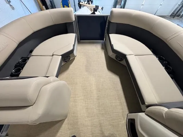 Slide: The Image of 2024 Harris Cruiser 210 interior with beige seating and cup holders. - 26