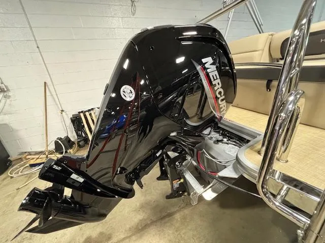 Slide: The Image of 2024 Harris Cruiser 210 with Mercury outboard motor in showroom. - 3