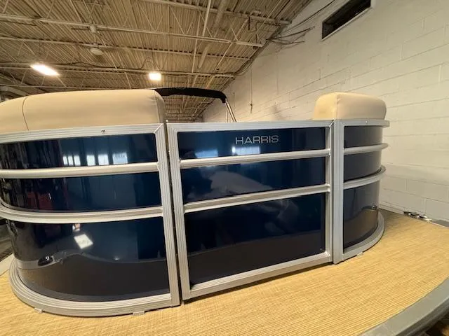Slide: The Image of 2024 Harris Cruiser 210 pontoon boat in indoor showroom. - 5