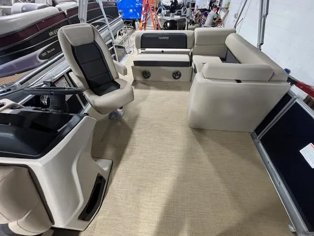 Slide: The Image of 2024 Harris Cruiser 210 pontoon boat interior with beige seating and modern helm. - 9
