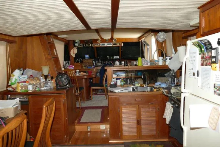 Slide: The Image of Interior of 1981 Blue Water Coastal Cruiser with wooden furnishings and kitchen area. - 8