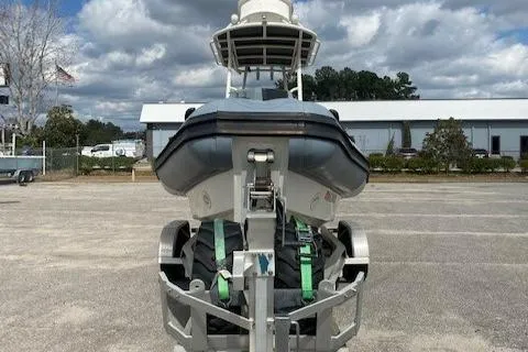 Slide: The Image of 2020 Ocean Craft Marine 24 boat on trailer, parked outdoors under cloudy sky. - 11