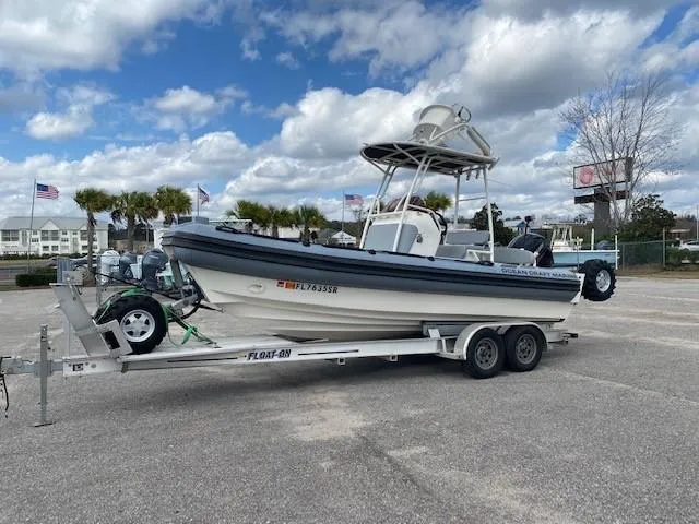 Slide: The Image of 2020 Ocean Craft Marine 24 boat on trailer under cloudy sky. - 4