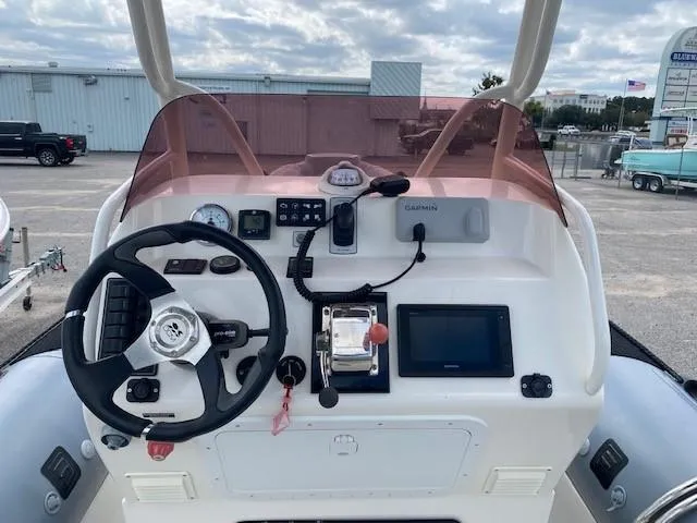 Slide: The Image of Control panel of 2020 Ocean Craft Marine 24 boat with steering wheel and navigation equipment. - 5