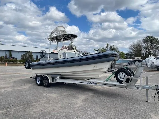 The Image of 2020 Ocean Craft Marine 24 boat on trailer under cloudy sky. - 0