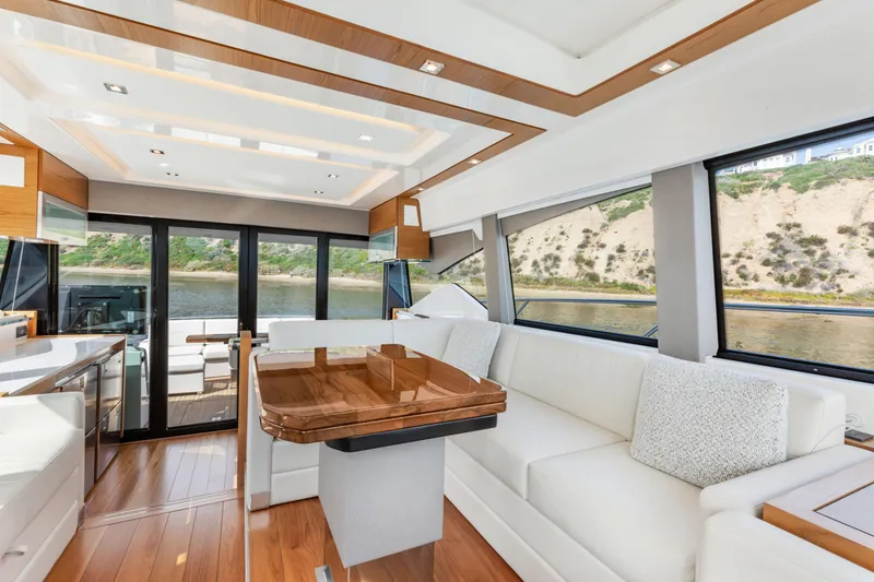 Slide: The Image of Luxurious interior of 2022 Tiara Yachts 53 Coupe with elegant wood and white furnishings. - 1