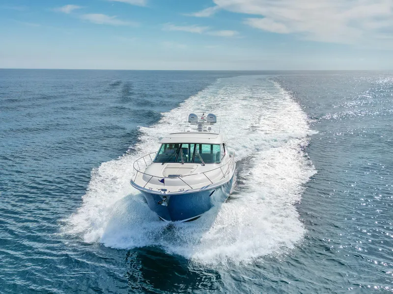 Slide: The Image of 2022 Tiara Yachts 53 Coupe cruising on open water. - 10