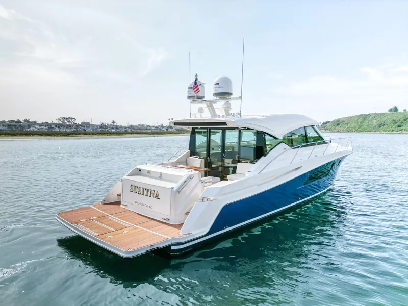Slide: The Image of 2022 Tiara Yachts 53 Coupe on water, rear view, sleek design, luxury motor yacht. - 13