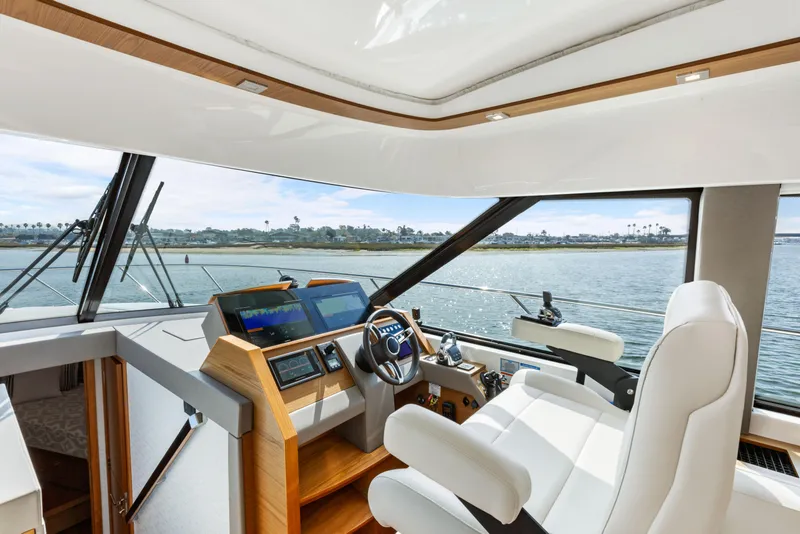 Slide: The Image of Interior helm of 2022 Tiara Yachts 53 Coupe with modern navigation system. - 2