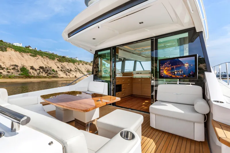 Slide: The Image of Luxurious 2022 Tiara Yachts 53 Coupe with elegant outdoor seating and scenic view. - 21
