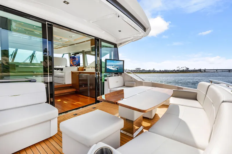 Slide: The Image of Luxurious 2022 Tiara Yachts 53 Coupe with elegant outdoor seating and scenic water view. - 22