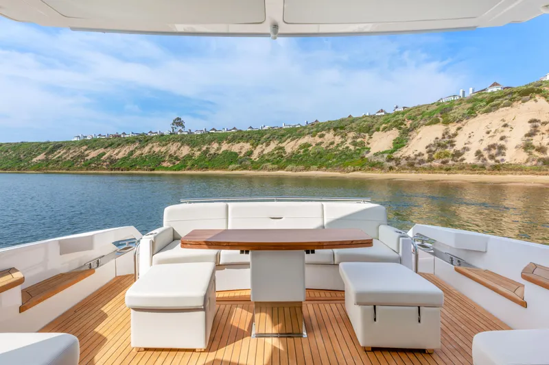 Slide: The Image of Luxurious 2022 Tiara Yachts 53 Coupe with elegant outdoor seating and scenic water view. - 24