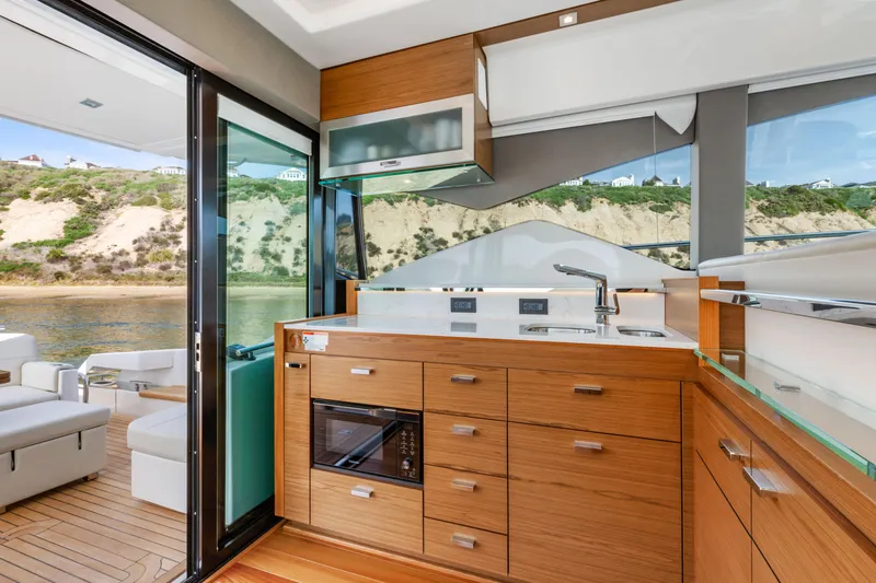 Slide: The Image of Luxurious interior of 2022 Tiara Yachts 53 Coupe with modern kitchen and scenic view. - 27