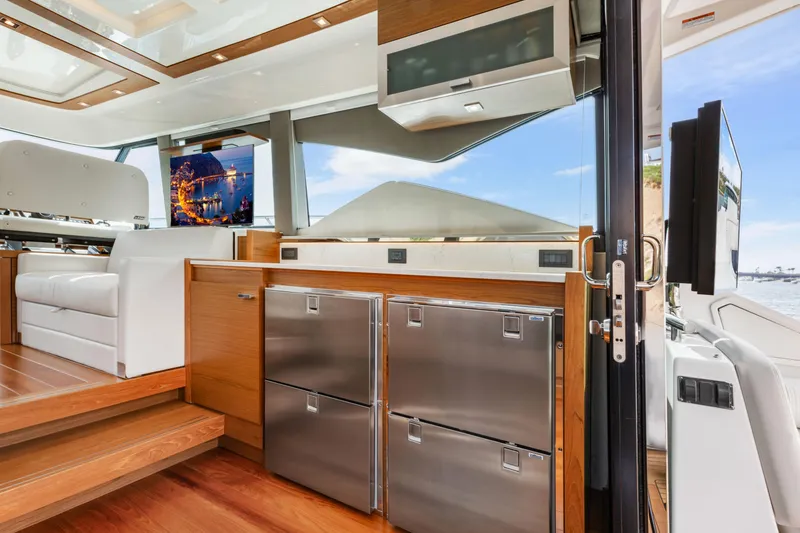 Slide: The Image of Luxurious interior of 2022 Tiara Yachts 53 Coupe with modern kitchen and seating area. - 28