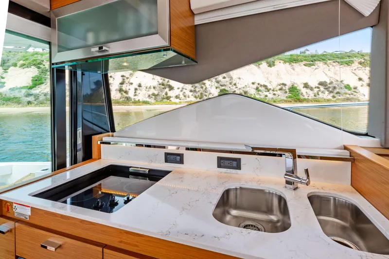 Slide: The Image of Luxurious kitchen interior of 2022 Tiara Yachts 53 Coupe with modern appliances and scenic view. - 29