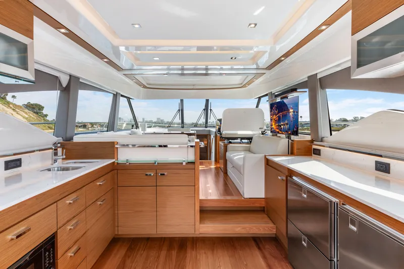 Slide: The Image of Luxurious interior of 2022 Tiara Yachts 53 Coupe with modern kitchen and seating area. - 3