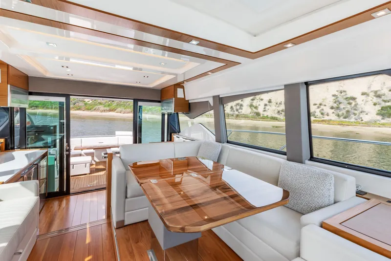 Slide: The Image of Luxurious interior of 2022 Tiara Yachts 53 Coupe with elegant wood finishes and panoramic windows. - 35