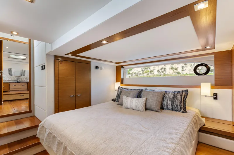 Slide: The Image of Luxurious bedroom interior of 2022 Tiara Yachts 53 Coupe with modern design and cozy bedding. - 4