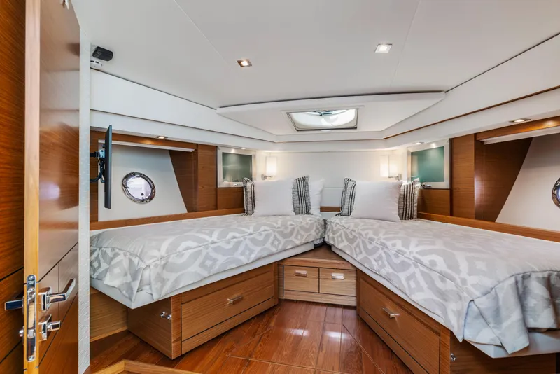 Slide: The Image of Luxurious 2022 Tiara Yachts 53 Coupe cabin with twin beds and elegant wood finish. - 41