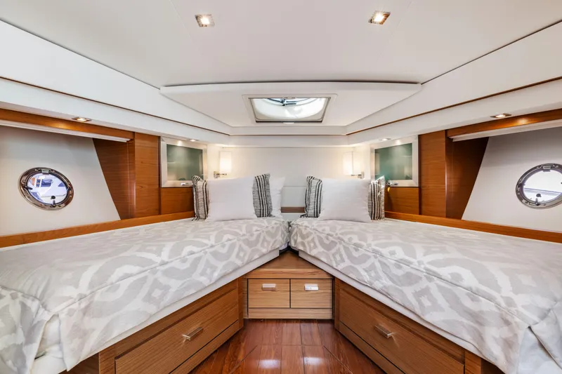 Slide: The Image of Luxurious 2022 Tiara Yachts 53 Coupe cabin with twin beds and elegant wood finish. - 42