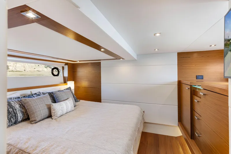 Slide: The Image of Luxurious bedroom interior of 2022 Tiara Yachts 53 Coupe with modern design and wood accents. - 44