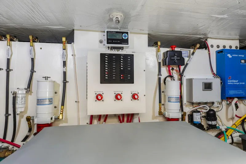 Slide: The Image of Engine room of 2022 Tiara Yachts 53 Coupe with control panel and equipment. - 49