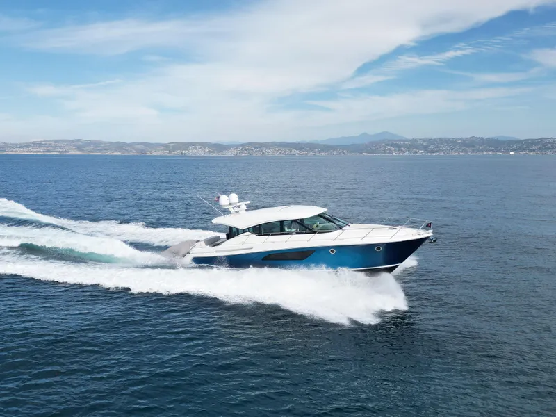Slide: The Image of 2022 Tiara Yachts 53 Coupe cruising on open water. - 6