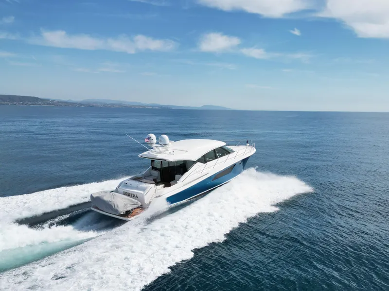Slide: The Image of 2022 Tiara Yachts 53 Coupe cruising on open water, showcasing sleek design and performance. - 7