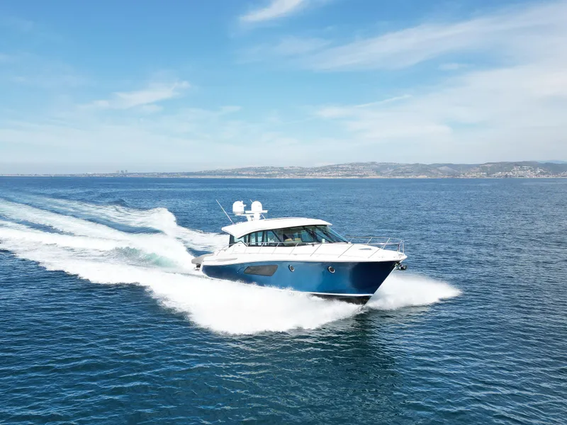 Slide: The Image of Tiara Yachts 2022 53 Coupe cruising on open water under clear skies. - 8