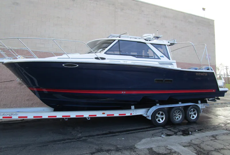 Slide: The Image of 2024 Cutwater C-288 C boat, docked outdoors, front view with railings and clear sky. - 3