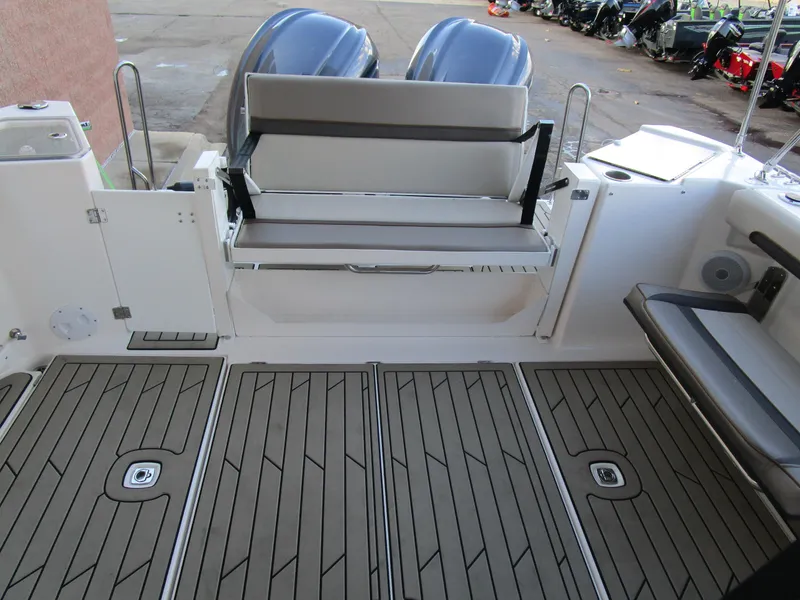 Slide: The Image of Interior of 2024 Cutwater C-288 C boat featuring a compact kitchenette and seating area. - 32