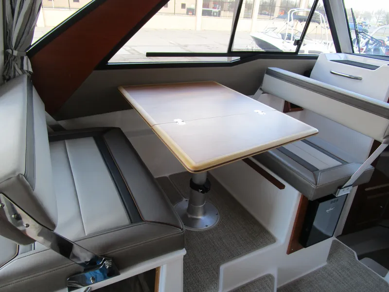 Slide: The Image of 2024 Cutwater C-288 C interior cabin with cozy seating and striped cushions. - 33