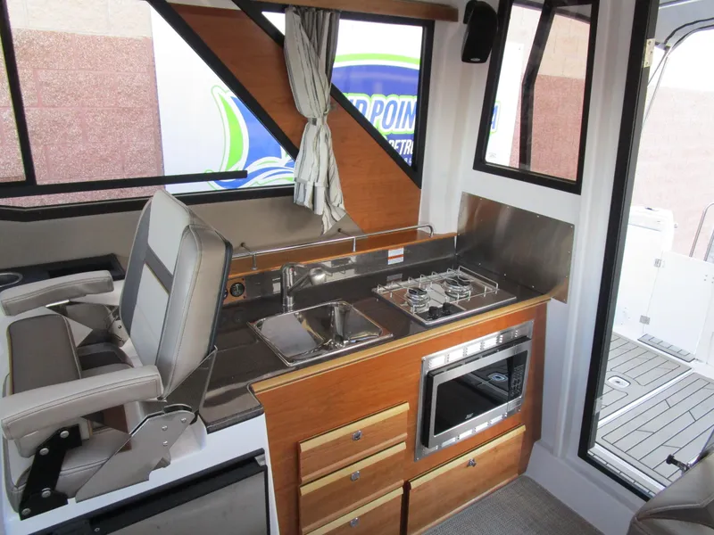 Slide: The Image of Interior view of 2024 Cutwater C-288 C boat, featuring sleek wood finish and modern fixtures. - 39