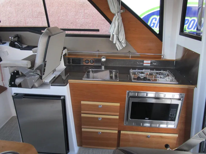 Slide: The Image of 2024 Cutwater C-288 C boat bathroom with modern sink, toilet, and wooden cabinetry. - 40