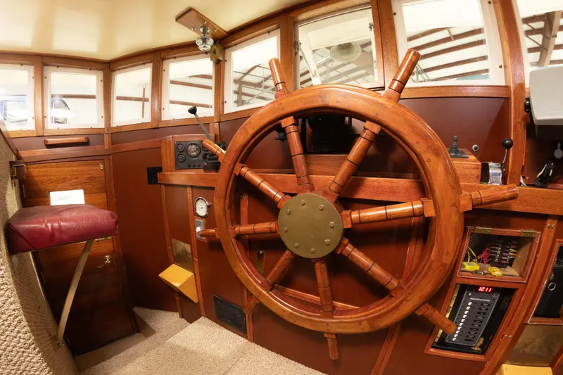 Slide: The Image of 1993 Custom Steel Trawler helm with wooden ship wheel and navigation instruments. - 13