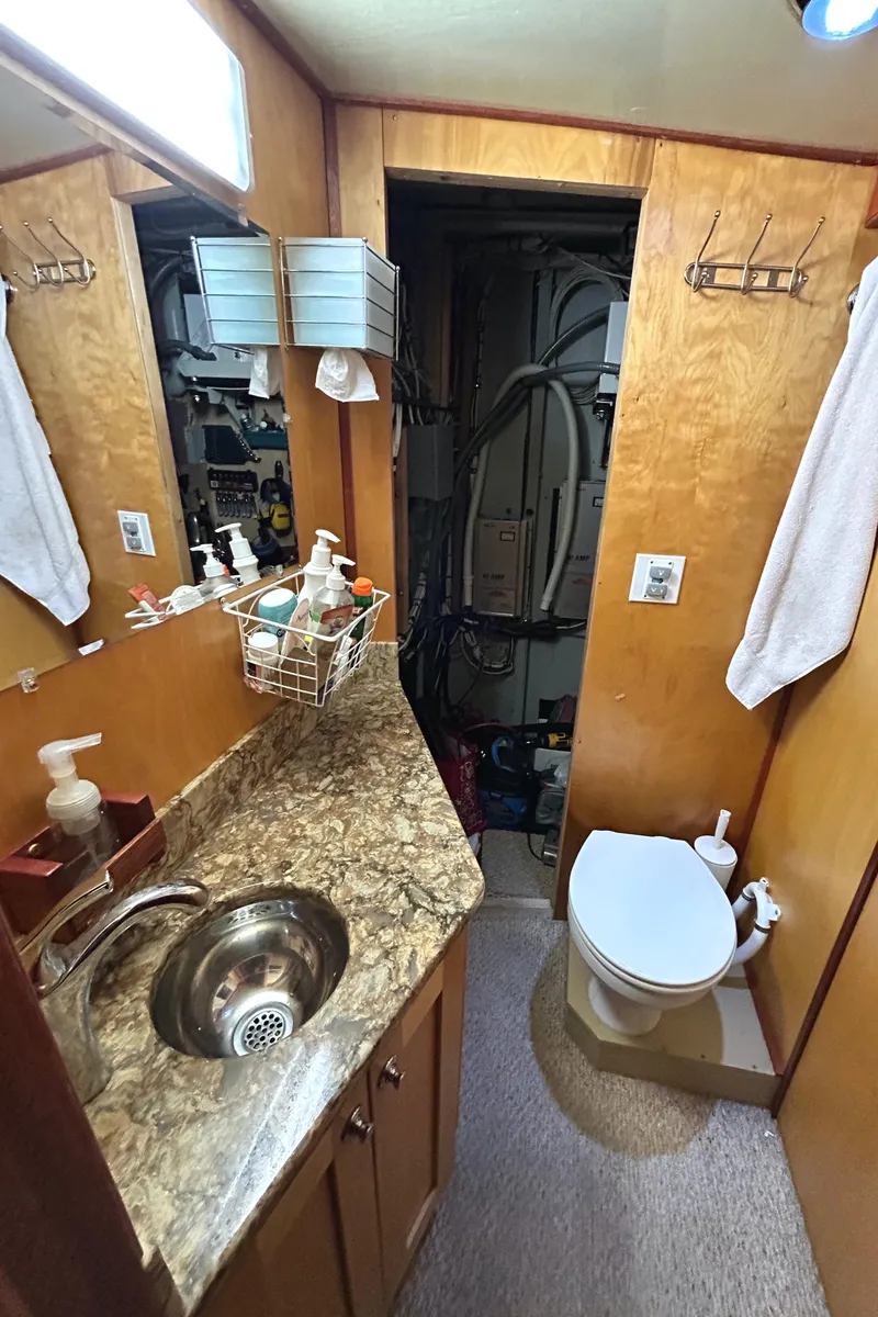 Slide: The Image of 1993 Custom Steel Trawler bathroom with sink, toilet, and storage. - 17