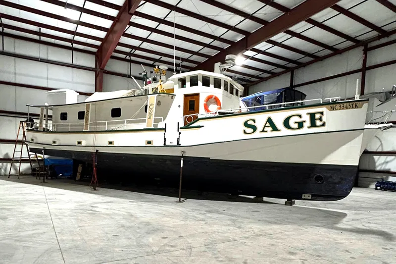 Slide: The Image of Custom 1993 Steel Trawler SAGE in a warehouse, side view. - 2