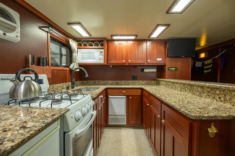Slide: The Image of Spacious kitchen in 1993 Custom Steel Trawler with granite countertops and modern appliances. - 22