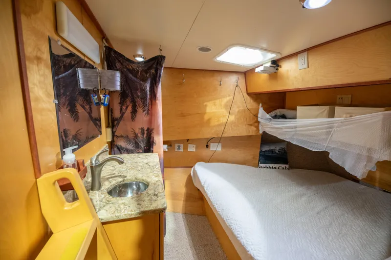 Slide: The Image of Cozy cabin interior of a 1993 Custom Steel Trawler with bed and sink. - 26