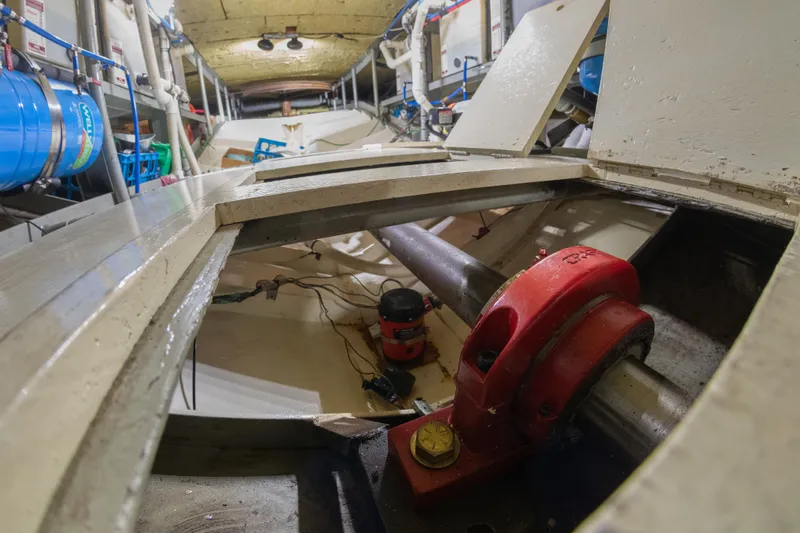 Slide: The Image of Engine room of a 1993 Custom Steel Trawler with visible machinery and equipment. - 27
