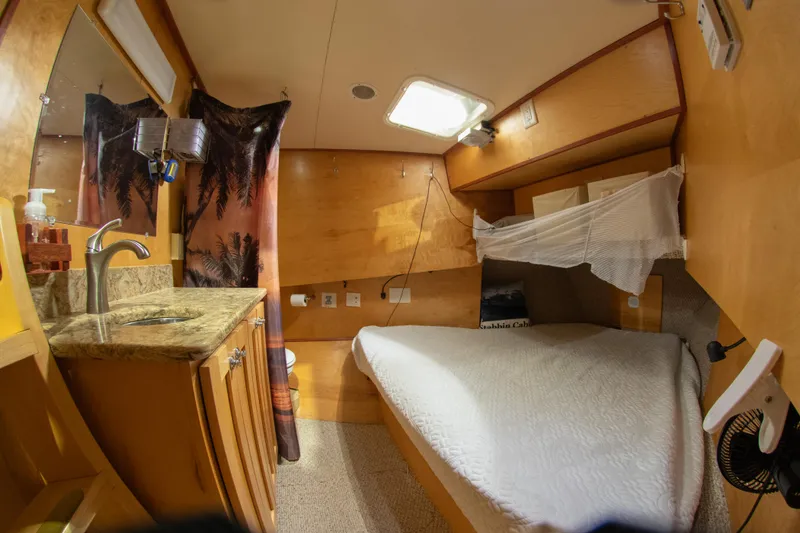 Slide: The Image of Cozy cabin interior of a 1993 Custom Steel Trawler with bed and sink. - 35