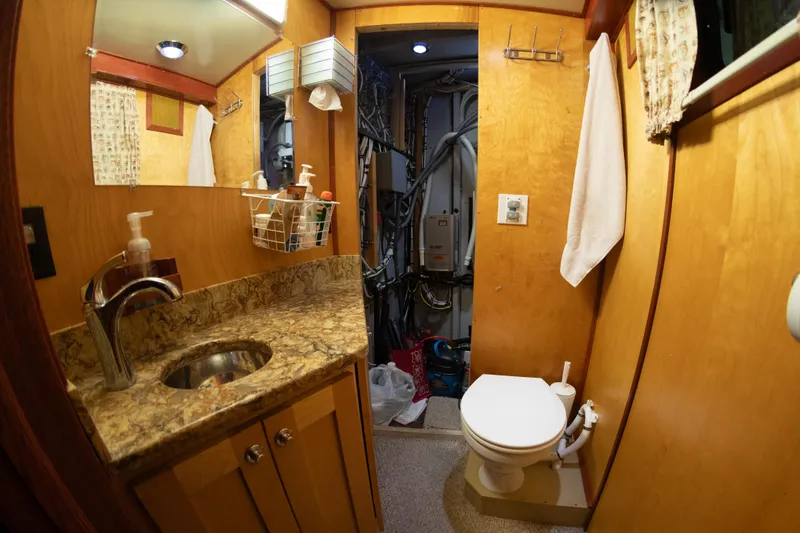 Slide: The Image of 1993 Custom Steel Trawler bathroom with sink, toilet, and storage. - 37