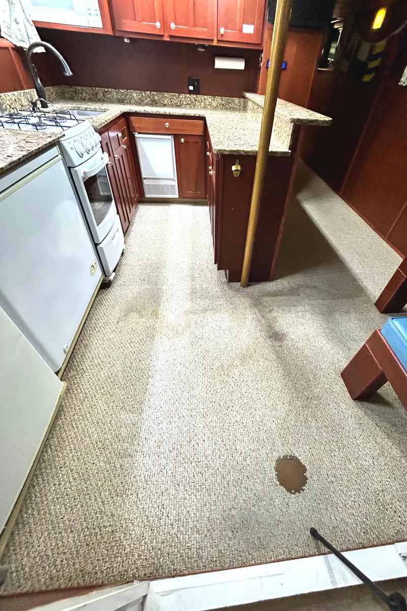 Slide: The Image of 1993 Custom Steel Trawler kitchen with granite countertops and carpeted floor. - 40